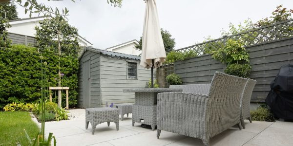Covered patio and outdoor living space remodel in San Antonio with table and seating