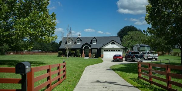 Driveway leading to a suburban house where a carport addition could provide covered parking in San Antonio