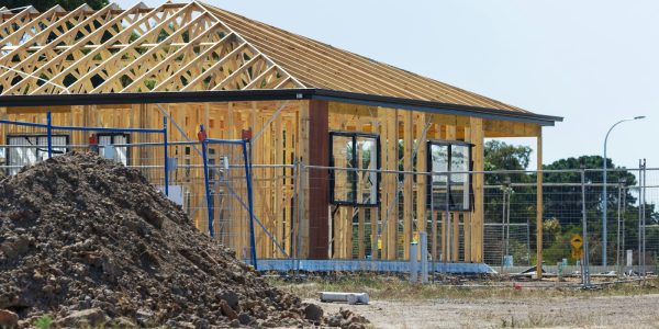 New home under construction with timber framing, illustrating a custom build versus remodel decision in San Antonio