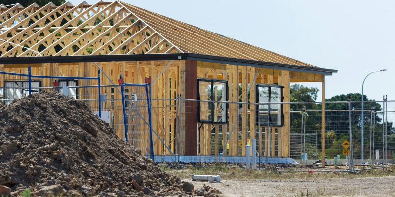 New home under construction with timber framing, illustrating a custom build versus remodel decision in San Antonio