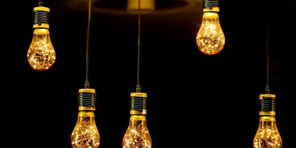 Glowing light bulbs representing energy-efficient remodeling upgrades that lower San Antonio utility bills