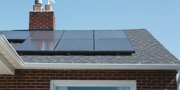 Brick home with rooftop solar panels representing energy upgrade incentives in San Antonio