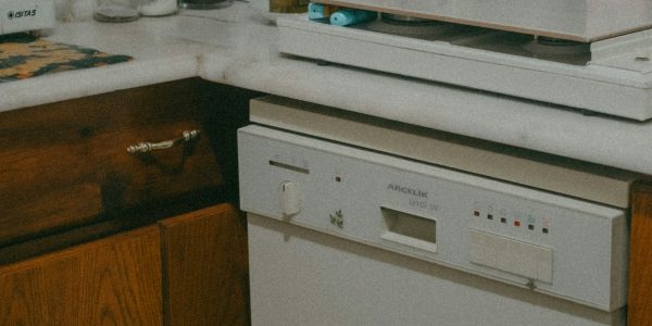 Aging kitchen with older cabinets and appliances showing it may be time to remodel a San Antonio home