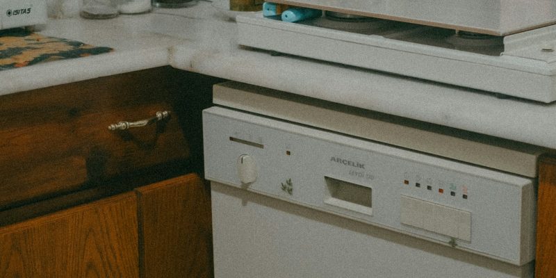 Aging kitchen with older cabinets and appliances showing it may be time to remodel a San Antonio home