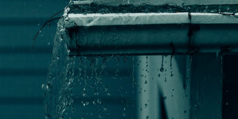 Rainwater falling from a roof edge, the source for a rainwater harvesting system in San Antonio