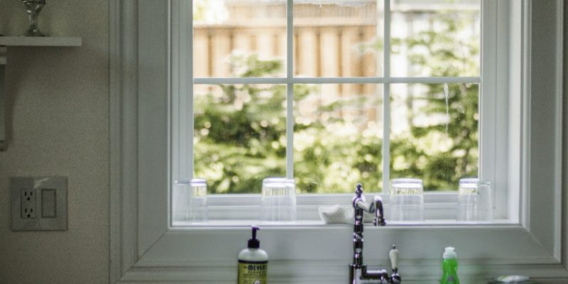 White-framed window above a kitchen sink illustrating window style choices for a San Antonio home