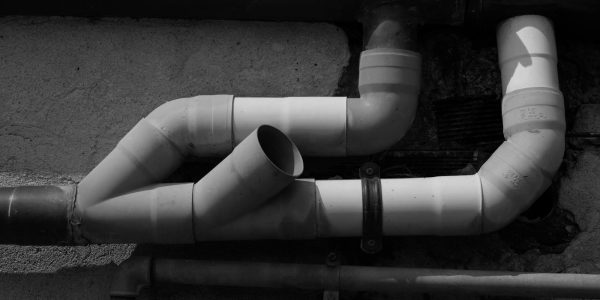 Plumbing pipes representing water heater installation in a San Antonio home remodel